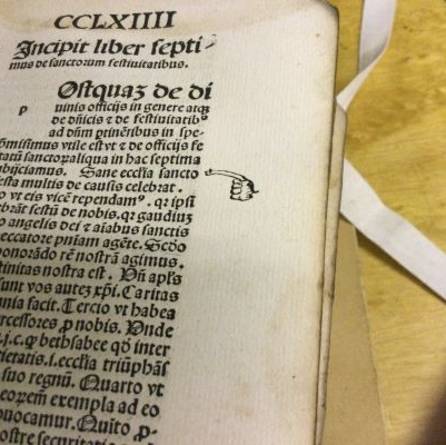 An early printed book with a marginal sketch of a hand